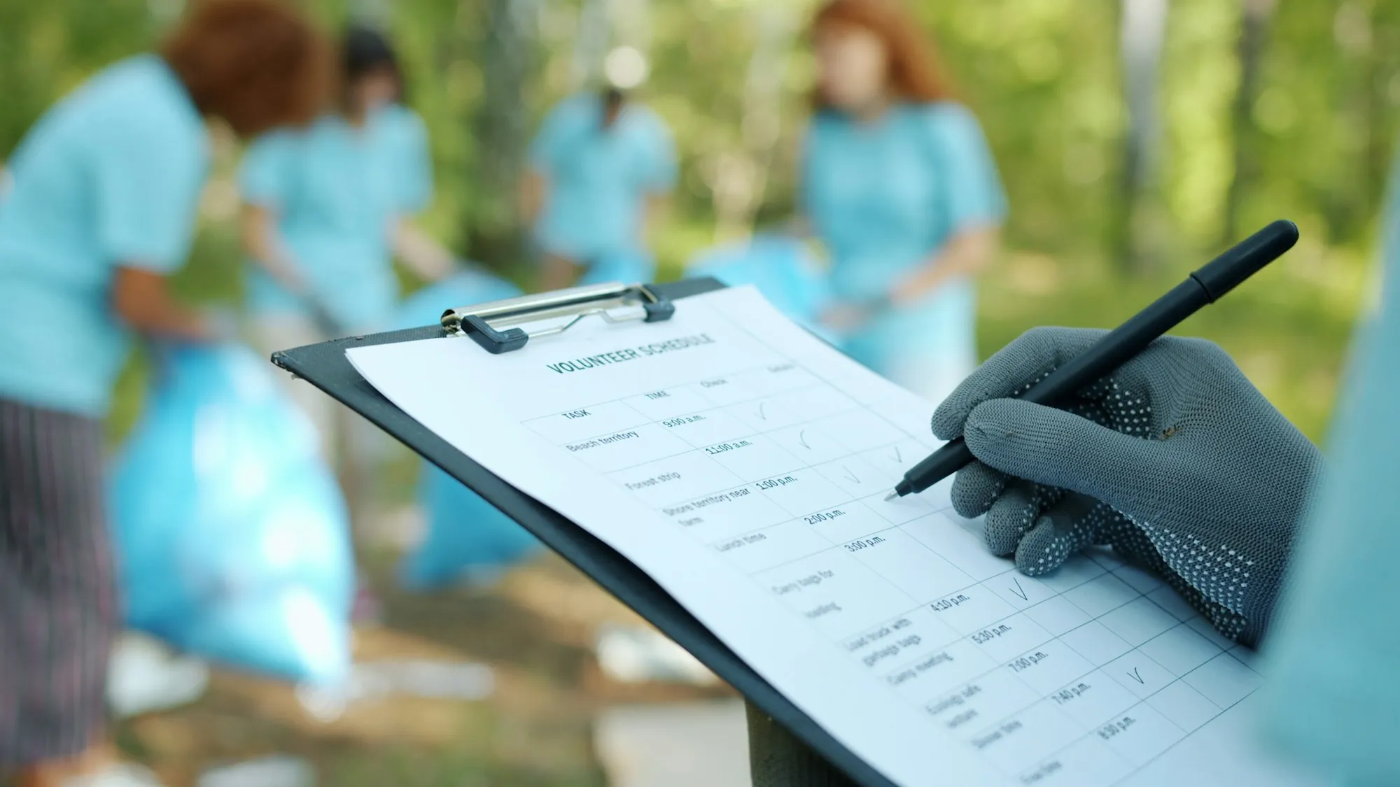 Gloved hand filling in an inspection form