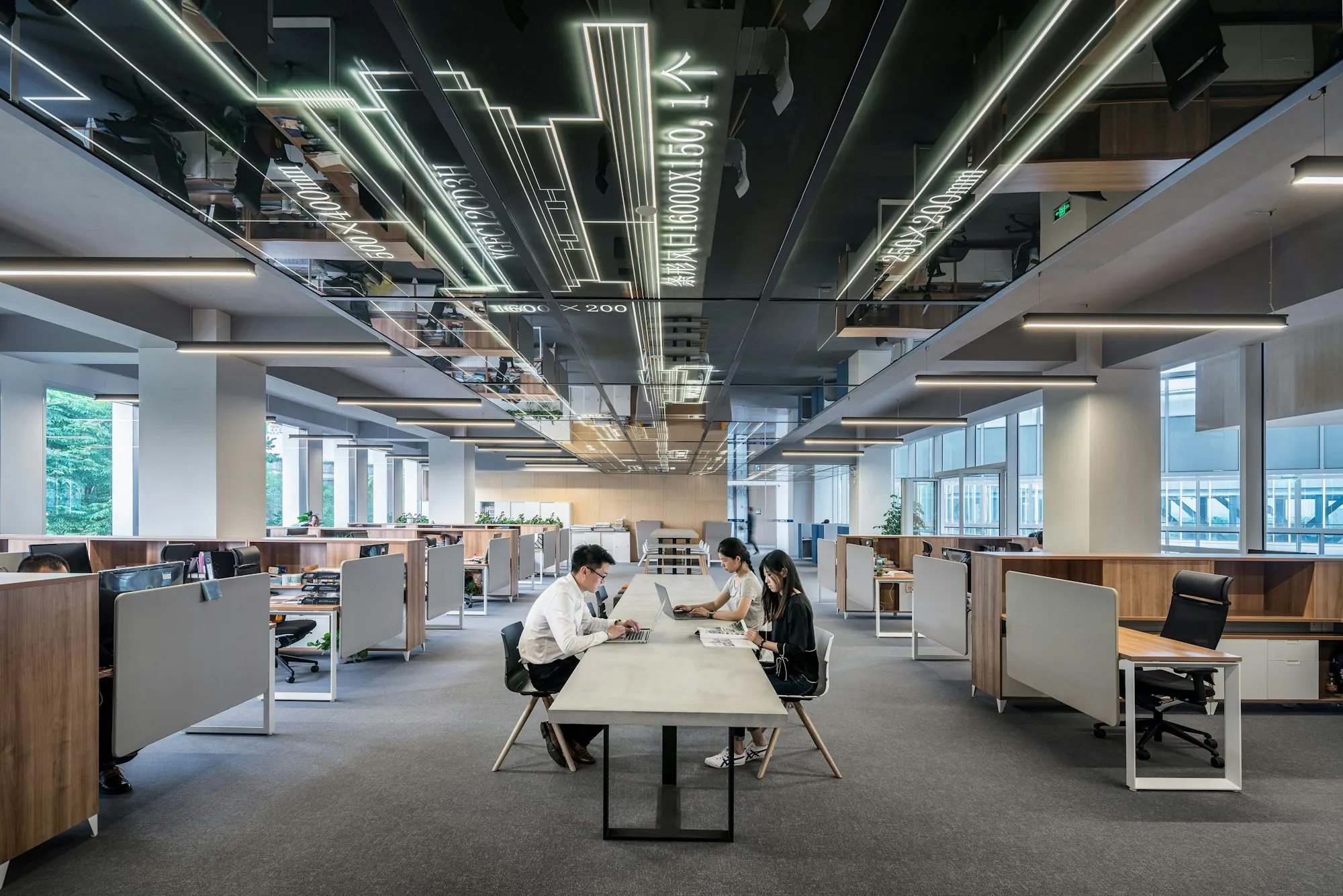 Open-plan office interior with exposed ceiling ducts